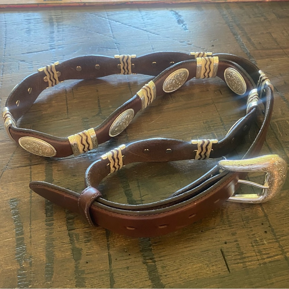 Western belt with rawhide/silver concho accents. Size 50.  1 1/2 inch width.